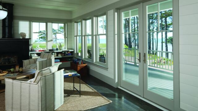 Andersen A-Series Double-Hung Windows, unequal cottage style sash, with specified equal light pattern (2 wide by 1 high, upper sash only). Andersen Frenchwood Patio Door Outswing, prefinished white interiors, with tall fractional grille pattern.