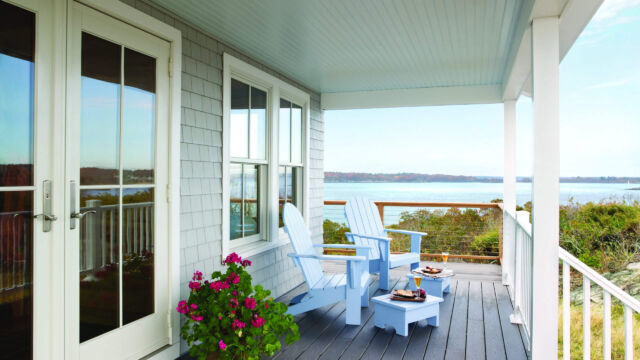Andersen A-Series Double-Hung windows with Specified Equal Light (2w x 1h) grille pattern. A-Series Frenchwood Hinged Outswing Patio Door with Specified Equal Light (2w x 2h) grille pattern. All with white exteriors.